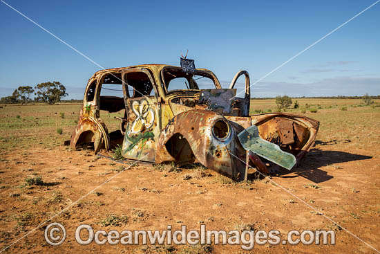 Old car riddled in bullet holes photo