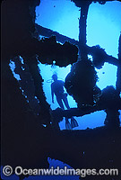 Scuba Diver exploring the historic SS Yongala shipwreck. Situated off Cape Bowling Green, near Townsville, Queensland, Australia.